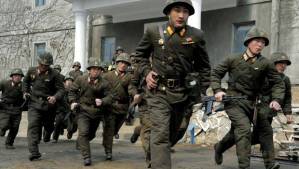North Korean troops running through a South Korean town.